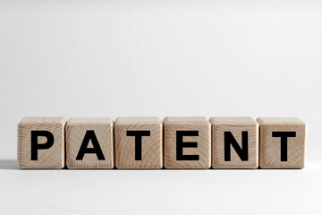 License. Word Patent made of wooden cubes with letters on white background