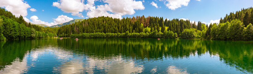 Panoramic view of Karagol Lake and forest. Landscape of a lake
