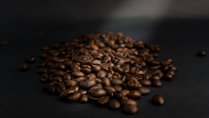  Roasted coffee beans are blackish brown, with a black background