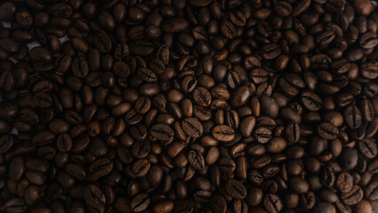  Roasted coffee beans are blackish brown, with a black background
