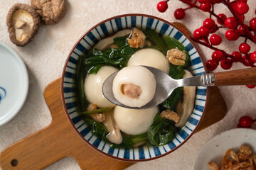 Eating big tangyuan yuanxiao with savory soup in Taiwan.