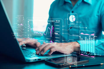 Working on laptops with Planning analysis and Project management online. Stock Market Investments and Digital Assets, analyzing forex trading graph financial data. Business finance background.