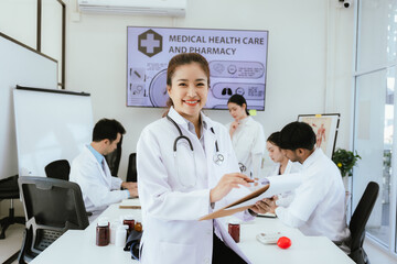 Fototapeta premium A diverse team of health care professionals, including doctors and nurses, sit and talk in a hospital office. The team works together to provide expert medical care and support to patients.
