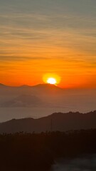 Golden Bromo Sunrise with Emerging Sun, Misty Mountains, and Cloud Sea