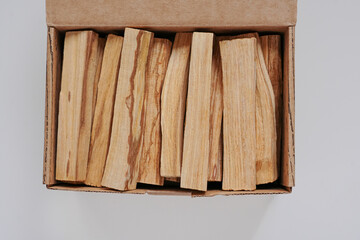 incense palo santo sticks wooden in a box on a white background flat lay close-up