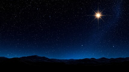 A star in the night sky over a mountain range