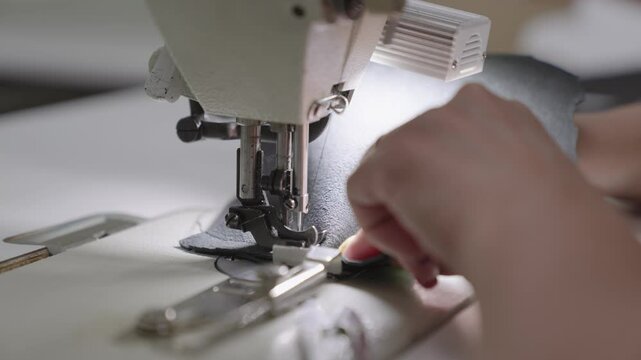sewing master special sewing machine sews leather product. making product from fabric leather. tailor working. hands close-up. production industry concept. workshop seamstress couturier order clothes