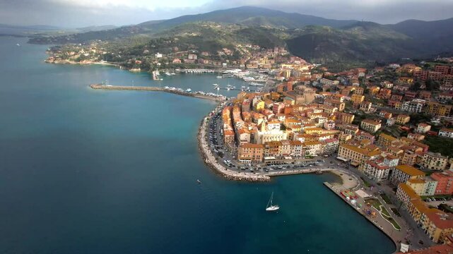 Italy , Tuscany summer destinations - beautiful coastal town Porto Santo Stefano , Grosseto province.High angle 4k hd drone video of scenic marina and bay
