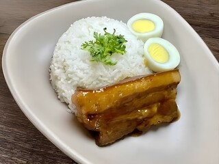 A visually appealing and seemingly simple bento-style meal. It features a neatly arranged portion...