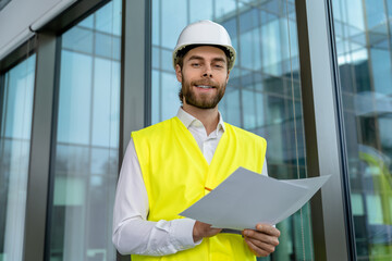 Young male engineer scrutinizing new project scheme and looking determined