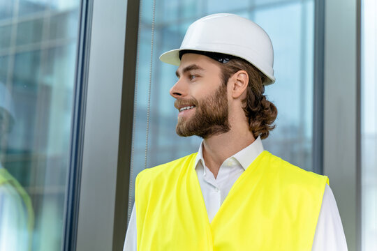 Waist up picture pf a you ng engineer in a hard cap