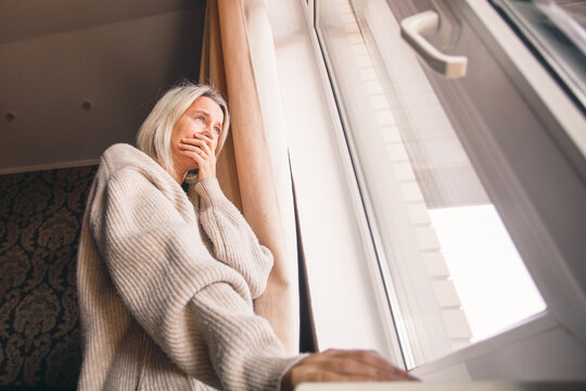 Sad pensive adult 40s woman at home