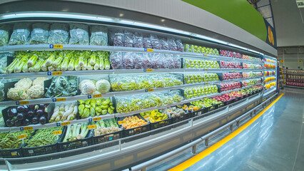 Fresh produce displayed on shelves in refrigerated section of supermarket