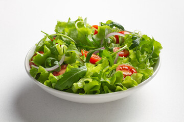 Fresh green salad on white background