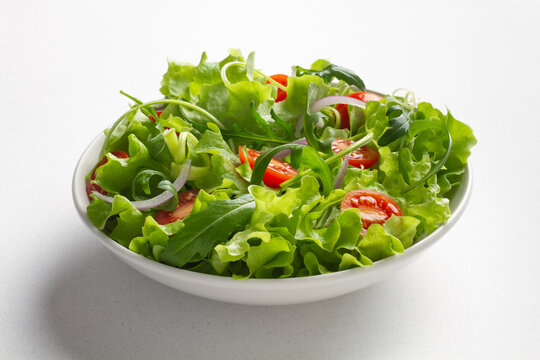 Fresh green salad on white background