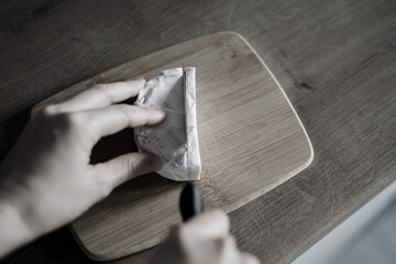 Woman cutting of freshly camembert cheese