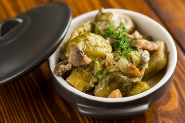 Brussel sprouts stewed in sour cream sauce with mushrooms and spices