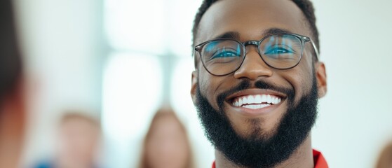 close up of a smiling man with glasses