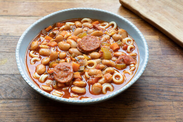 Pasta with tomatoes, beans, and sausage soup.