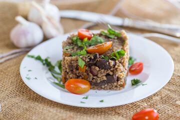 boiled bulgur in a plate with cherry tomatoes