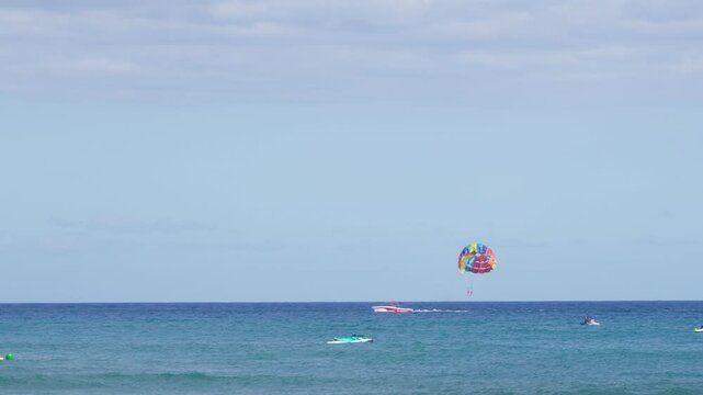 Colorful parasailing adventure over blue ocean waters