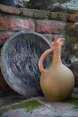 The  view of an earthenware jug and an old wooden plate