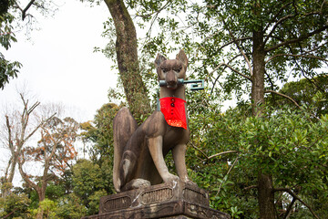 A statue of a fox (kitsune) at Fushimi Inari Taisha in Kyoto, Japan