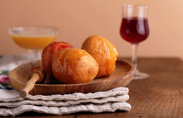 Italian Carnival Fritters with honey - Carnival Strufoli typical Umbrian sweet dish for Carnival, on a wooden plate on rustic background.