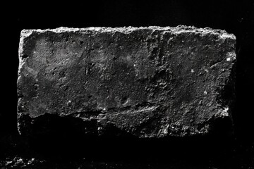 Dark monochromatic brick texture resting against a stark black background