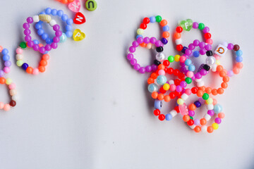 Set of three beaded children bracelets on a white background closeup