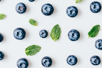 White background featuring isolated blueberries with leaves