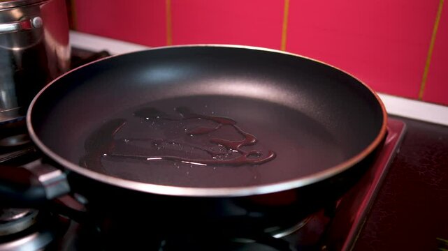 add oil to the pan melting in frying pan. Cube of butter melting sizzling browning in non stick pan skillet, preparation for cooking