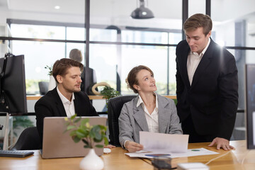Colleagues collaborating on a project in a modern office
