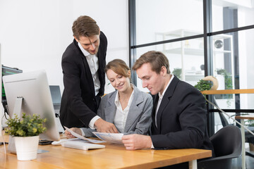 Colleagues collaborating on a project in a modern office