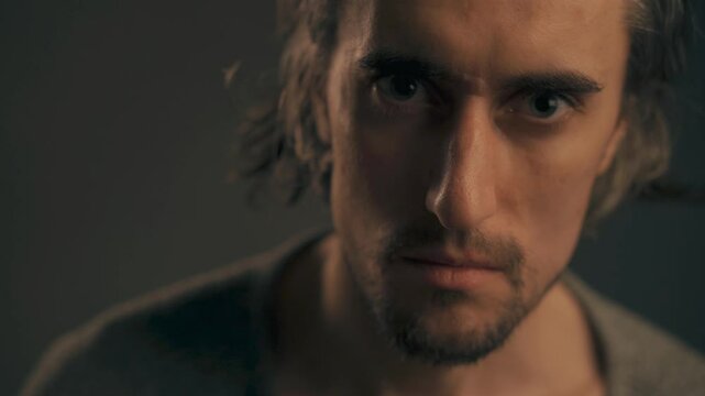 No Intense Young Man Serious gaze from a handsome European male with long hair and big eyes shaking his head negatively at the camera