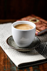 Cup of coffee on wooden background. Soft focus.