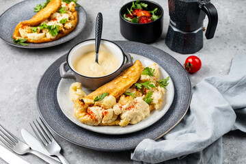 Fluffy omelet with cauliflower for breakfast with a cup of coffee