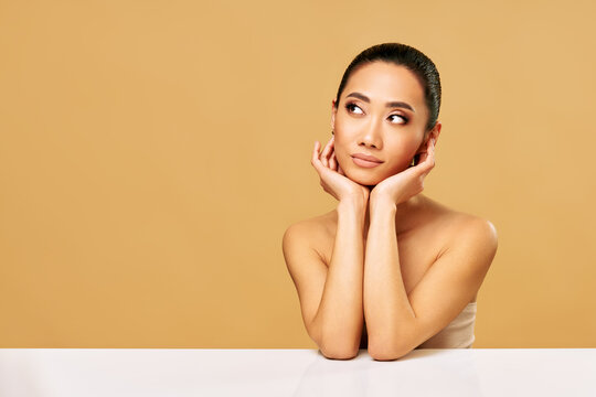 Beautiful smiling woman portrait looking aside on copy space
