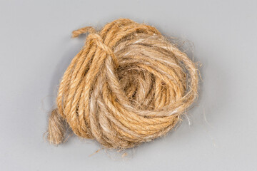 Small skein of different natural twines on a gray background