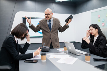 Male software developer meeting in modern office with stressed employees, documents, laptops, sales planning, digital marketing and growth strategies, analysis with colorful charts and graphs.