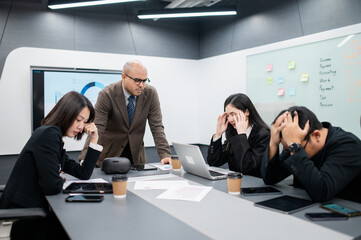 Male software developer meeting in modern office with stressed employees, documents, laptops, sales planning, digital marketing and growth strategies, analysis with colorful charts and graphs.