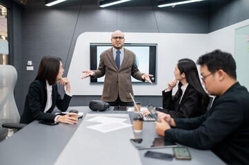 Male software developer meeting in modern office with stressed employees, documents, laptops, sales planning, digital marketing and growth strategies, analysis with colorful charts and graphs.