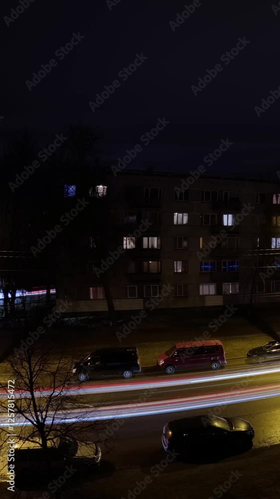 Poster vertical time lapse of vibrant light trails from moving cars create dynamic patterns against a backd