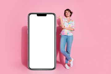 Full body portrait of nice young woman direct finger empty space smart phone display isolated on...