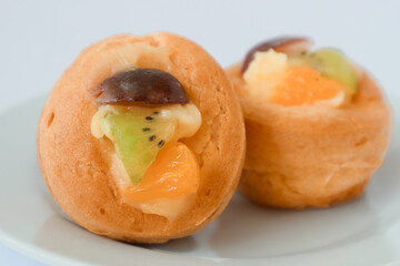 Fruit Soes Cake is filled with fla and topping grape,sweet orange, cherry, peach. In Indonesia it's...