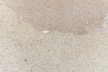 abstract background of an old restored beige embossed plastered wall close up