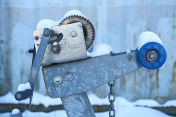 Close-up of metal trailer winch, used for pulling boat onto the trailer. Outside marina or harbor...