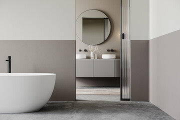 Luxury bathroom with a freestanding white bathtub, black faucet, wooden spa stool, and a connected vanity area with a round mirror. Modern minimalist design with natural light. 3D rendering