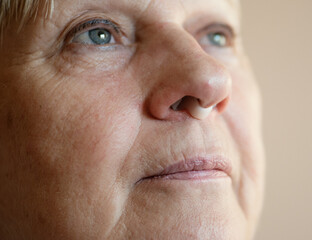 Portrait of aged woman wearing nose anti-snoring device.