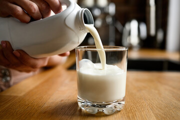 Girl with milk at kitchen at home